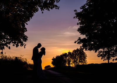 Couple under the trees at sunset at Stone Barn Cotswolds