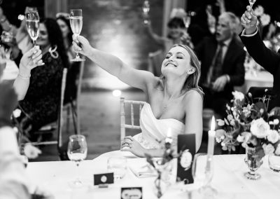 Bride raising her glass at elmore court